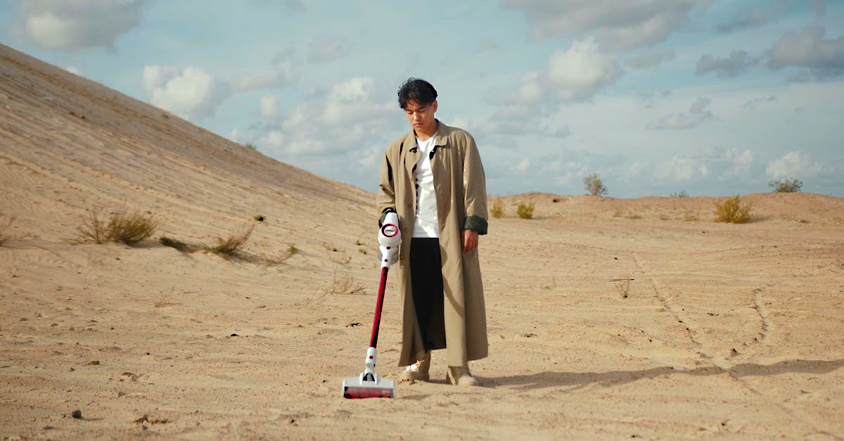 Man vacuuming the desert.